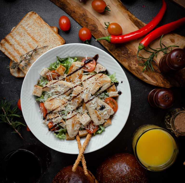 A bowl of creamy homemade chicken salad served with crackers and fresh lettuce, inspired by a famous recipe.