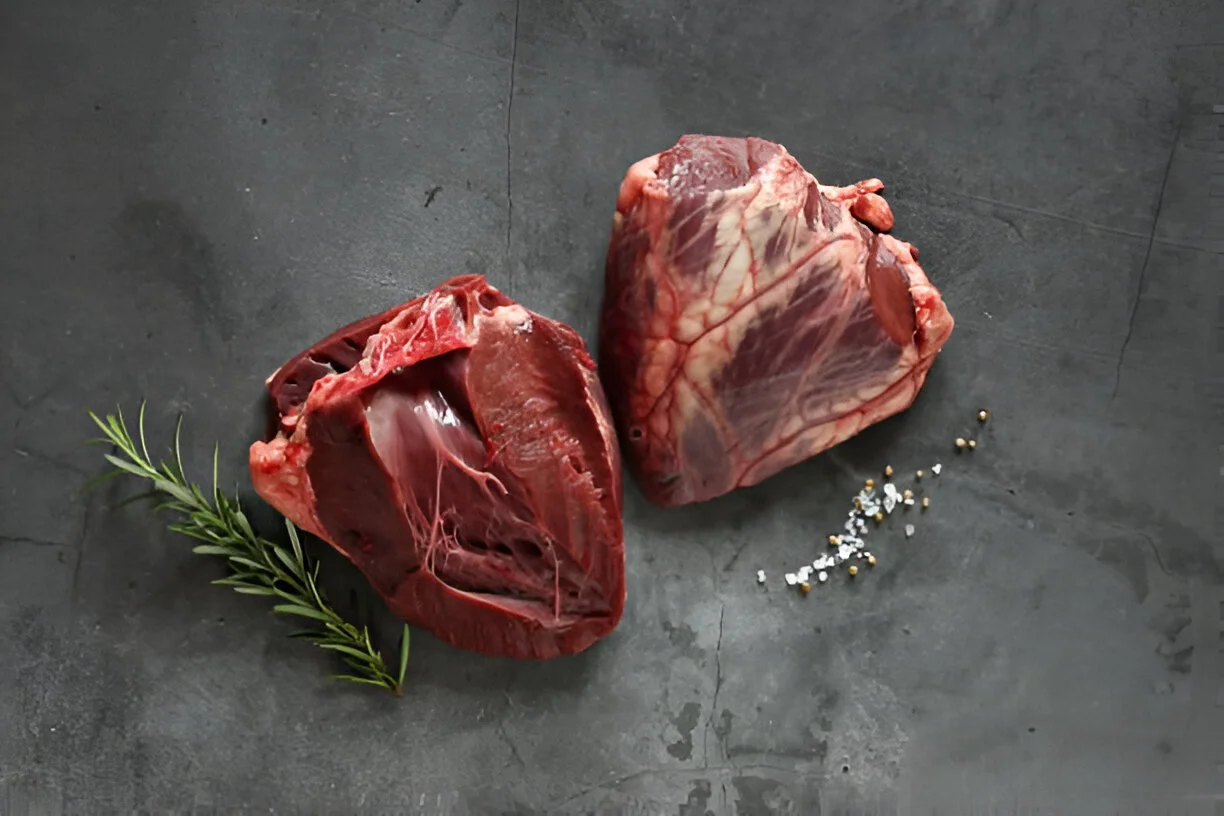 Beef heart recipe cooked and sliced on a plate with vegetables