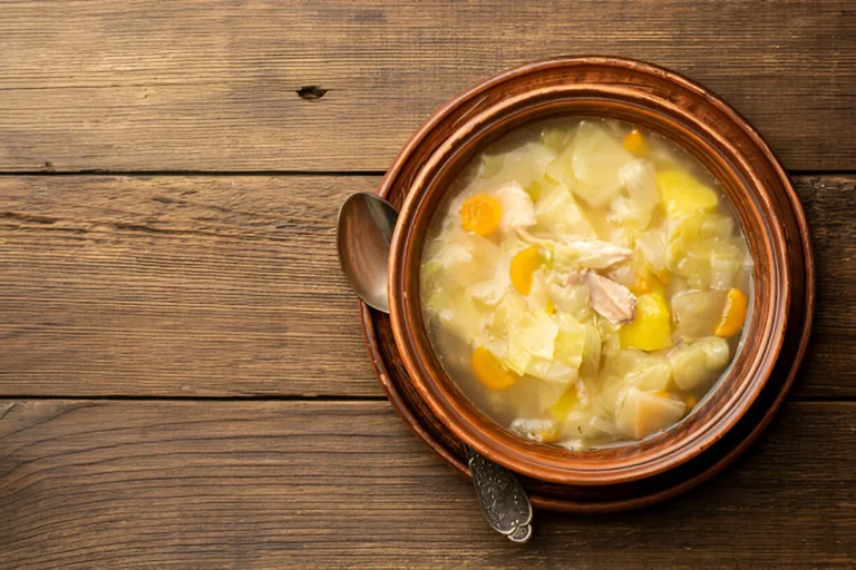 A bowl of Chicken Cabbage Soup with tender chicken, vibrant cabbage, and fresh vegetables in a rich broth.